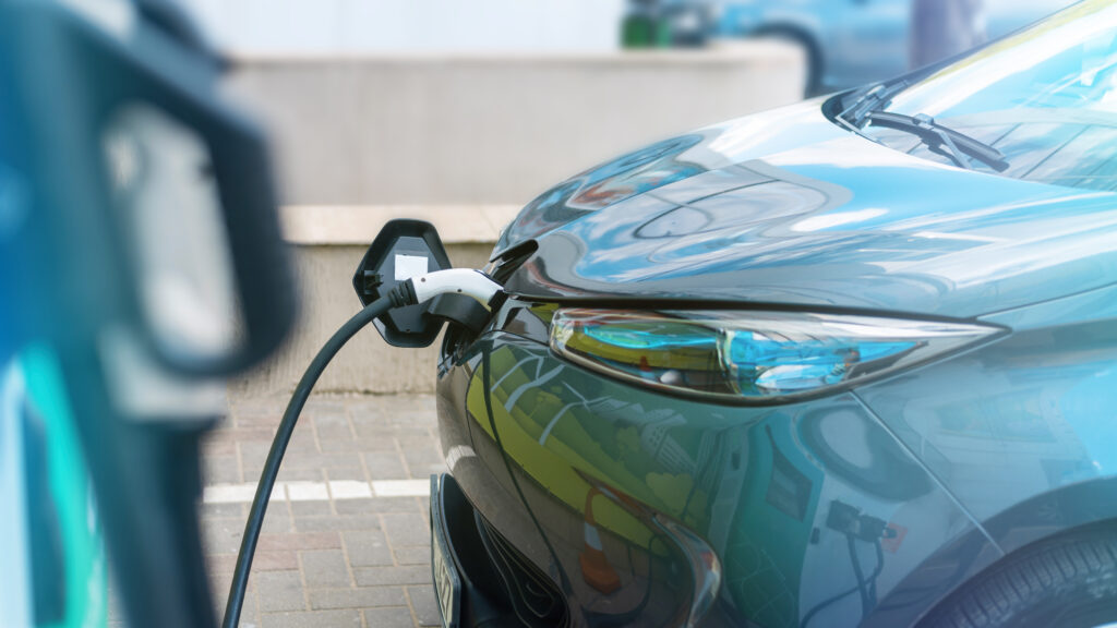 Plugged charger into electric car charge station